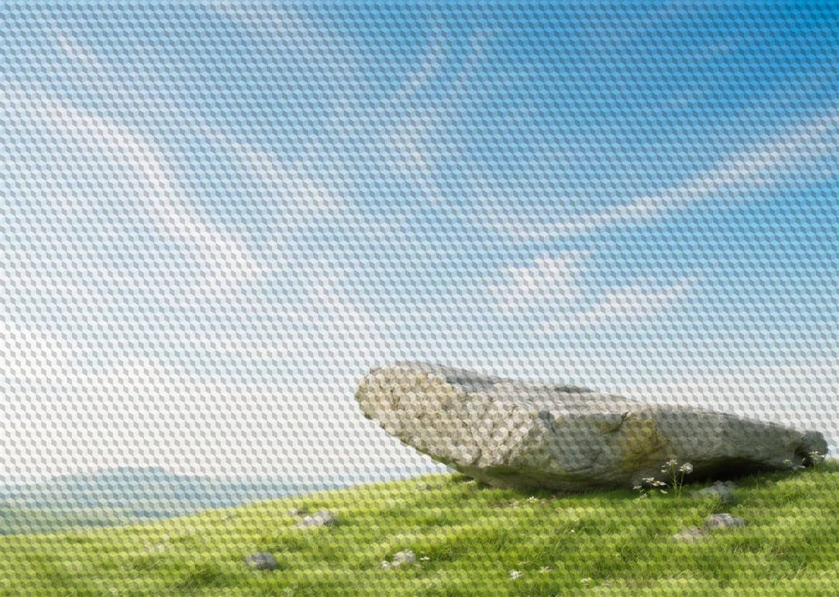 A solid rock resting on a green hillside, overlaid with a fine checking grid