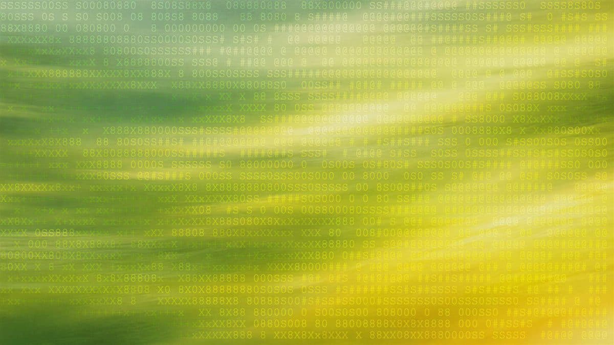 Waves of green grass turning gold in the light, textured with soft code